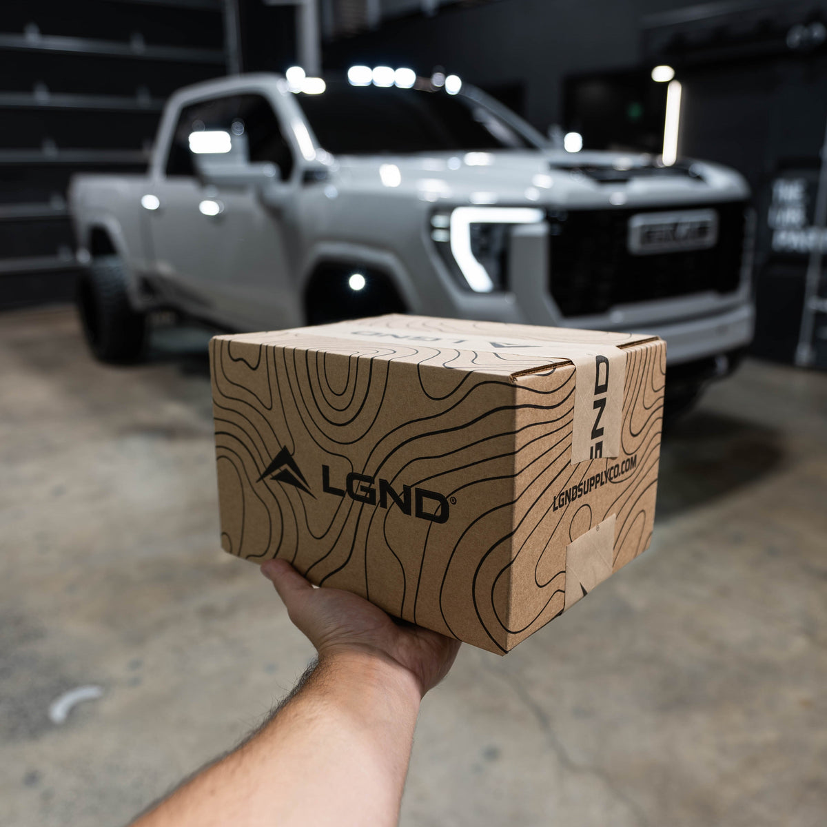 LGND Mystery Gear Box held in front of the GMC Denali at the LAB