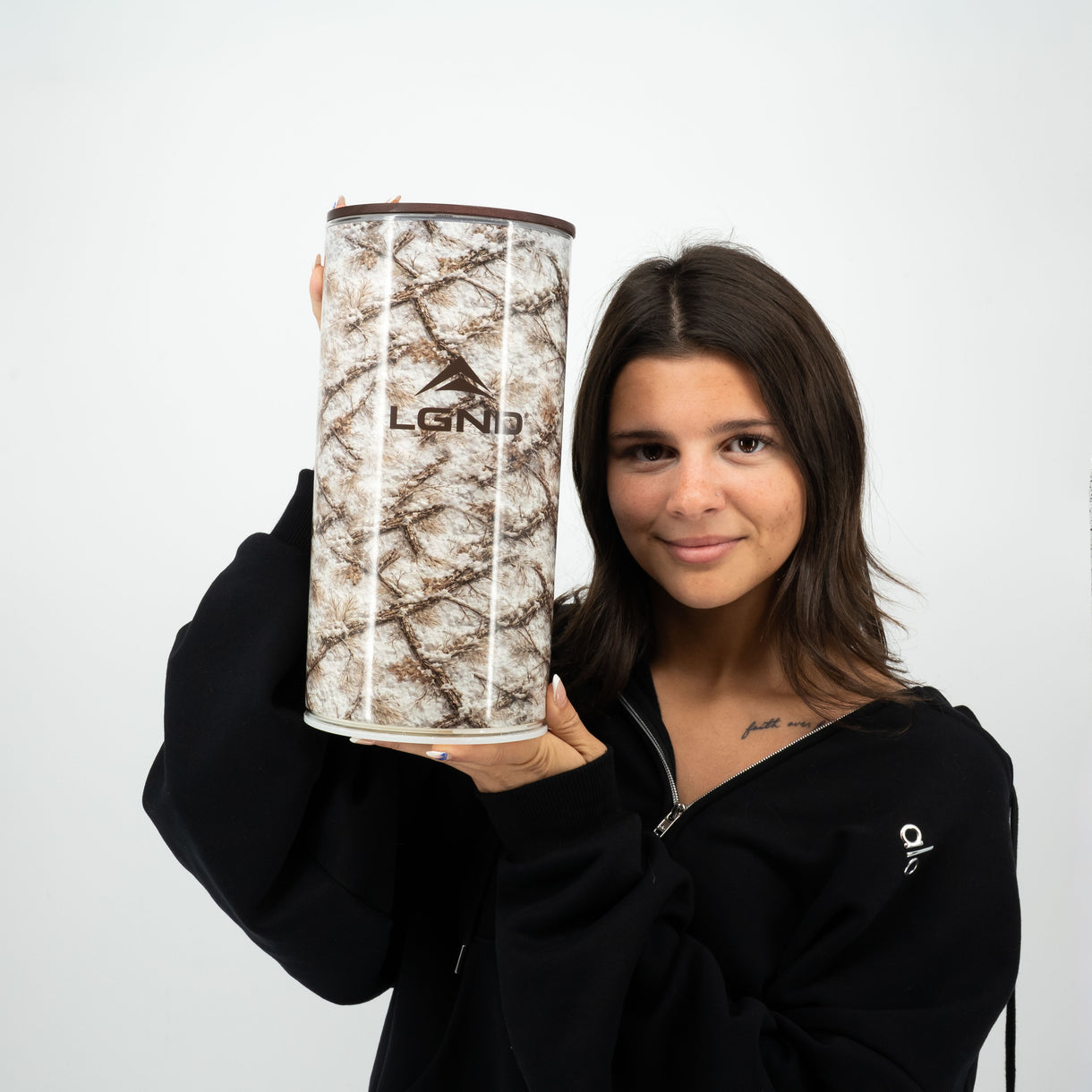 Person holding an oversized LGND Outdoors Big Candle